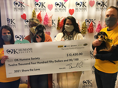 loves employees present donation check to ok humane society team