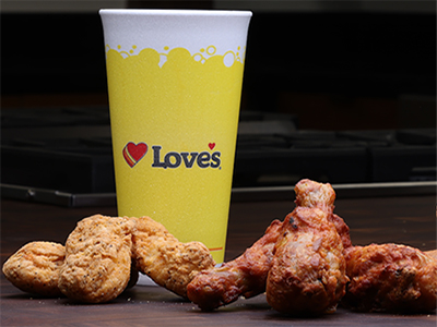 Love's Chicken Tenders and Spicy Drumsticks in front of Love's fountain cup
