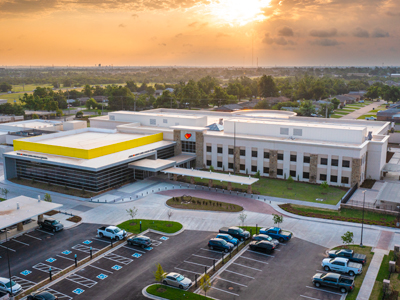 drone photo of Love's corporate office with sunset behind it