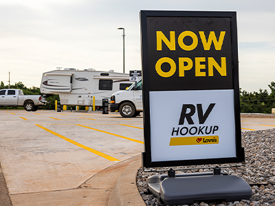 Now open RV sign in front of an RV.