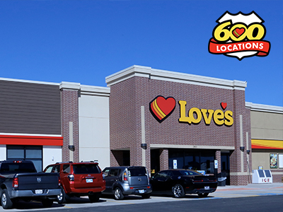 Front of a Love's Travel Stop building with cars parked in the front.