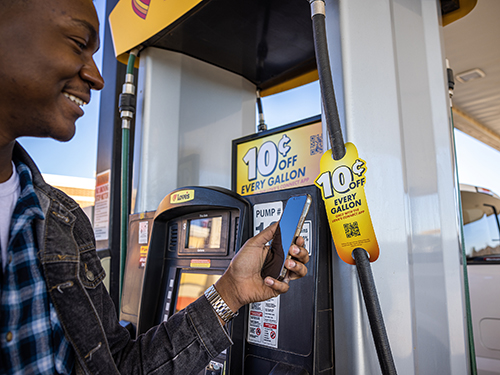 A person scanning a Love's Connect App barcode to redeem a 10¢ discount at a Love's pump