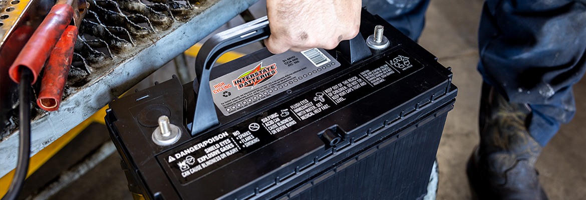 Interstate Battery on rack next to jumper cables