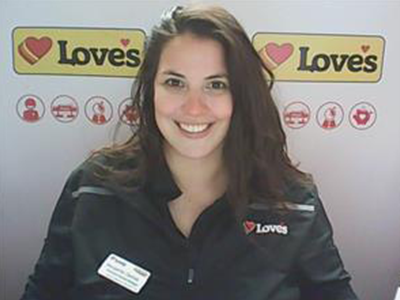 A women standing in front of a Love's Travel Stop background. 