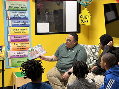 A photo of a Love's employee reading to students at Urban League of Greater Oklahoma City