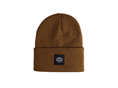 A brown knitted hat with a buffalo on the front