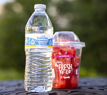 Love's bottled water and fresh fruit cup